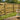 A view of treated fencing with a sandtimer inthe foreground.  How long does treated timbe last?