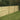 Horizontal slatted panels supported by round top treated posts