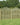 A row of Omega lattice top fence panels